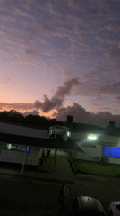 Illuminated building captured against colorful dusk sky in Kibaha
