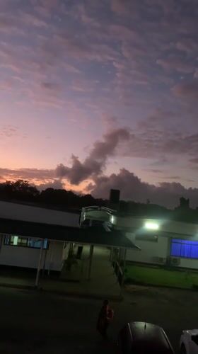 Illuminated building captured against colorful dusk sky in Kibaha