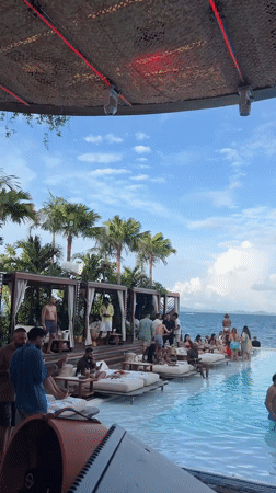 Poolside party with pizza and sushi, overlooking Thai islands.