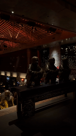 Dark restaurant interior with red-lit wooden beams captured in LA