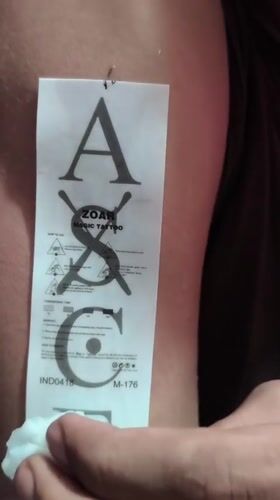 Person applies tattoos, takes selfies with K-pop merchandise in Depok