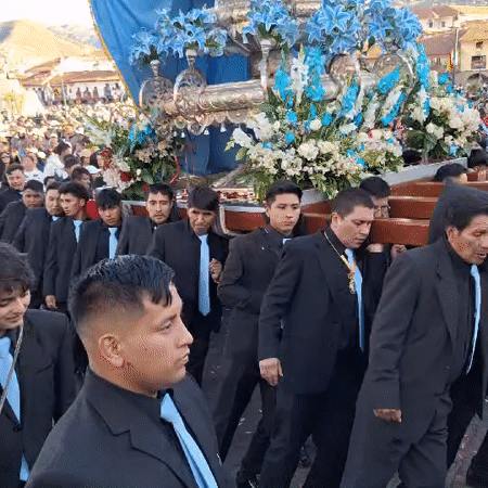 Religious procession with Virgin Mary float observed in Cuzco