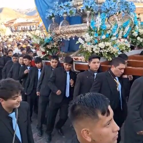Religious procession with Virgin Mary float observed in Cuzco