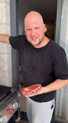 Man grills steaks on balcony in Ashkelon Friday afternoon