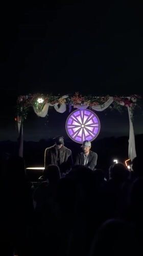 DJs perform nighttime set in San Diego beneath illuminated backdrop