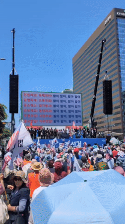 Early morning protest with Korean-American flags in Seoul's Gwanghwamun Square