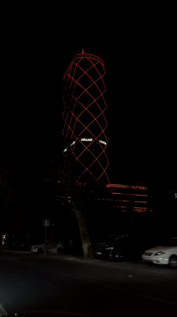 Tashkent's Pyramid Tower glows at night from a passing vehicle