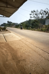 Morning street life along a rural road in Perambahan, Indonesia