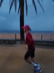Runner spotted jogging on Calella beach wearing distinctive pink cap