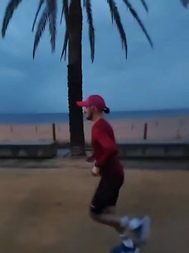Runner spotted jogging on Calella beach wearing distinctive pink cap