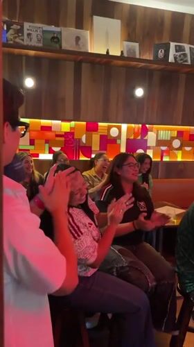 Late-night bar gathering in Puebla with food, drinks, and football