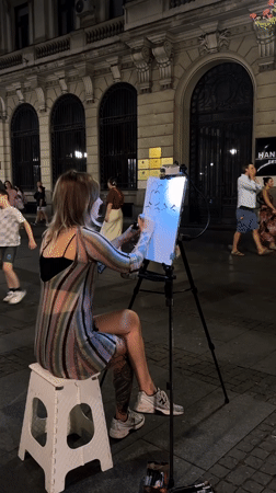 Street caricature artist at work on a Belgrade night