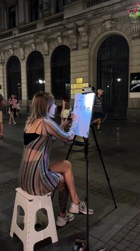 Street caricature artist at work on a Belgrade night