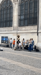 Brass band performs outdoor concert in Paris public square