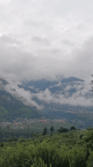 Manali valley town wrapped in monsoon clouds and mist