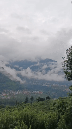 Manali valley town wrapped in monsoon clouds and mist