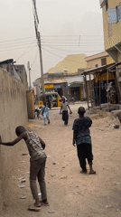 Daily life documented in dusty residential neighborhood