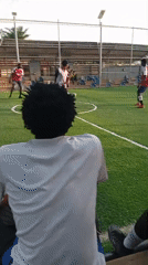 Soccer game and formal event setup documented simultaneously