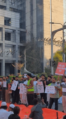 Protesters gather in Dhaka with bilingual signs, media coverage