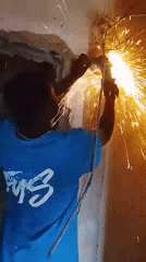 Angle grinder tears through concrete-embedded rebar in a spray of sparks