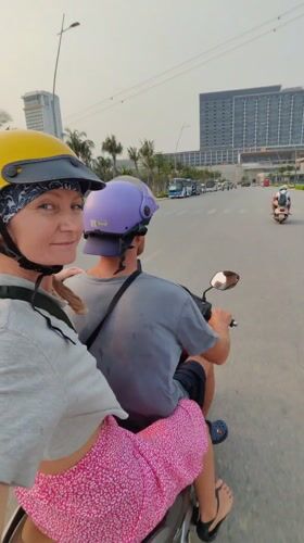 Woman films while riding scooter passenger in Bai Chay