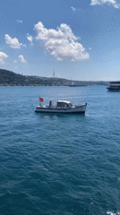 Bosphorus traffic: ferries, cargo ships, and small boats on a clear morning