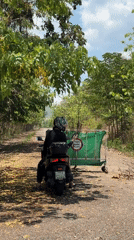 Motorcyclist spotted near road barrier in Thailand