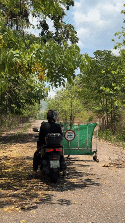 Motorcyclist spotted near road barrier in Thailand