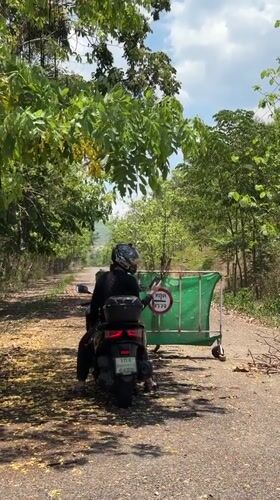 Motorcyclist spotted near road barrier in Thailand