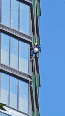 Window cleaner performs routine building maintenance in Khimki