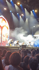 Fog-filled stage show with dancers and a live vocalist performing