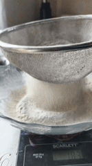 Home baker measures flour for bread preparation in Belarus