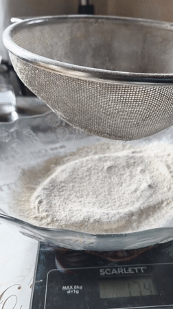 Home baker measures flour for bread preparation in Belarus