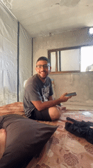 On the phone inside a Gaza room, mid-conversation