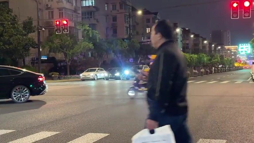 Evening street activity captured at Shanghai intersection