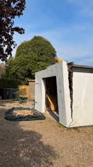 Man demolishes wall section of outbuilding in Stotfold yard