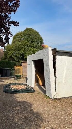 Man demolishes wall section of outbuilding in Stotfold yard