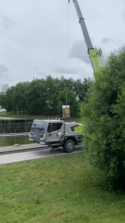 Construction crane operates near waterfront park in Kazan