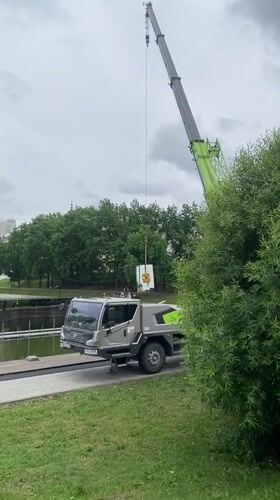 Construction crane operates near waterfront park in Kazan