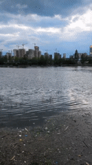 Moscow waterfront captures casual moments: ferry, soccer, debris