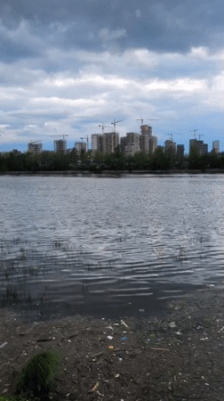 Moscow waterfront captures casual moments: ferry, soccer, debris