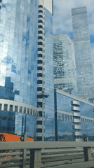 Driving past Moscow City's glass skyscraper cluster on a cloudy day