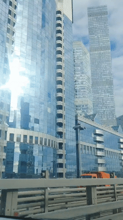 Driving past Moscow City's glass skyscraper cluster on a cloudy day