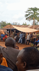 Community gathering with speeches and traditional dancing in DRC villages