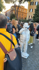 White-painted living statue performer draws crowds in Rome square