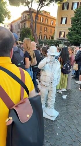 White-painted living statue performer draws crowds in Rome square