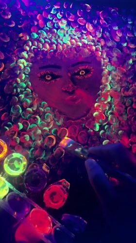 Artist creates blacklight portrait with colorful dots in Mozhga