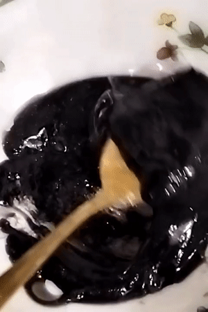 Dhaka resident prepares dark viscous liquid with spheres