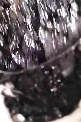 Dhaka resident prepares dark viscous liquid with spheres