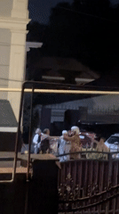Nighttime gathering outside a building in Almaty